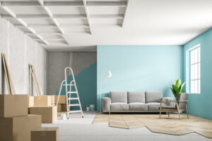 Blue living room interior with a gray sofa during renovation process. Unfinished floor, boxes and a ladder in the corner. 3d rendering mock up