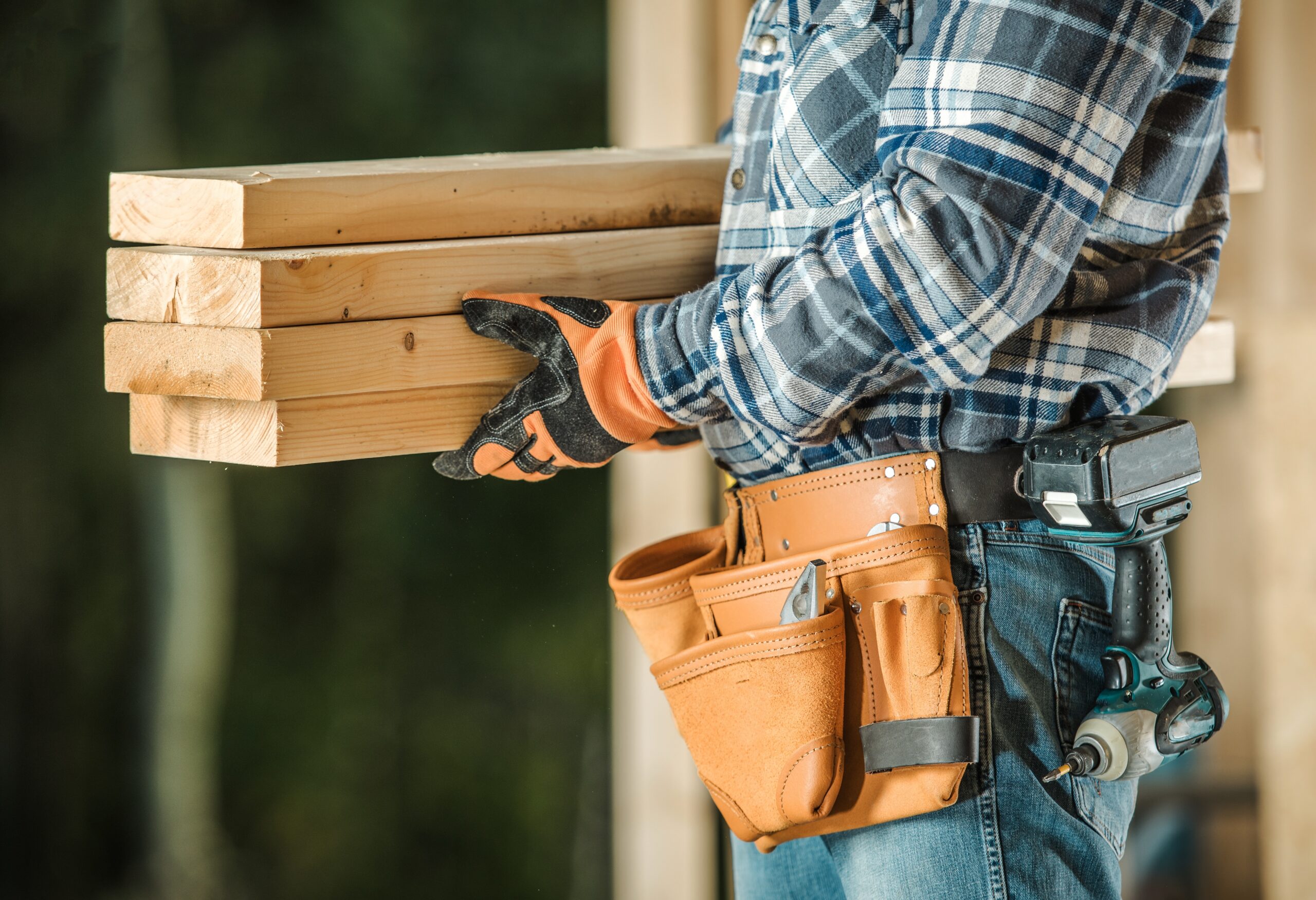 Caucasian Construction Contractor With Wood Beams. Closeup Photo.